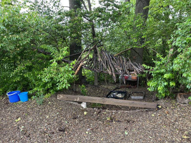 Stick roof and old wood balance beam in the playground